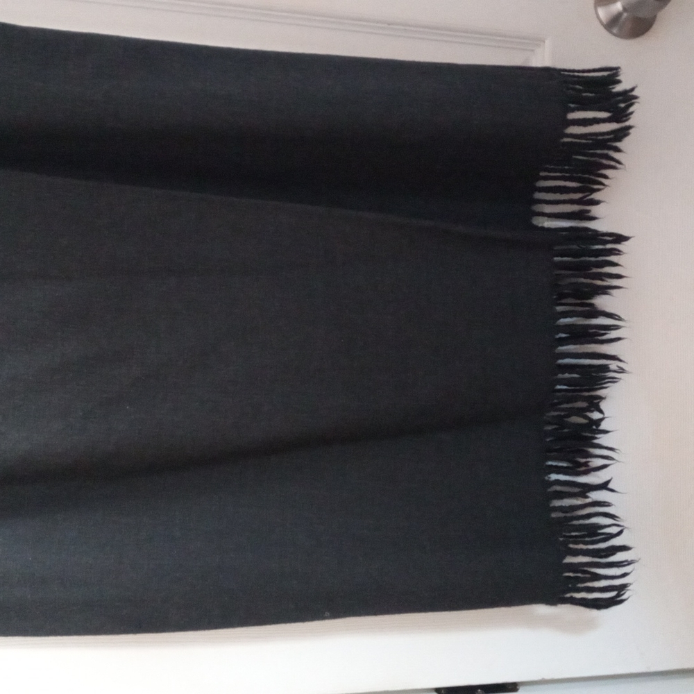 Women charcoal  grey wool skirt, with the fringes at the bottom.